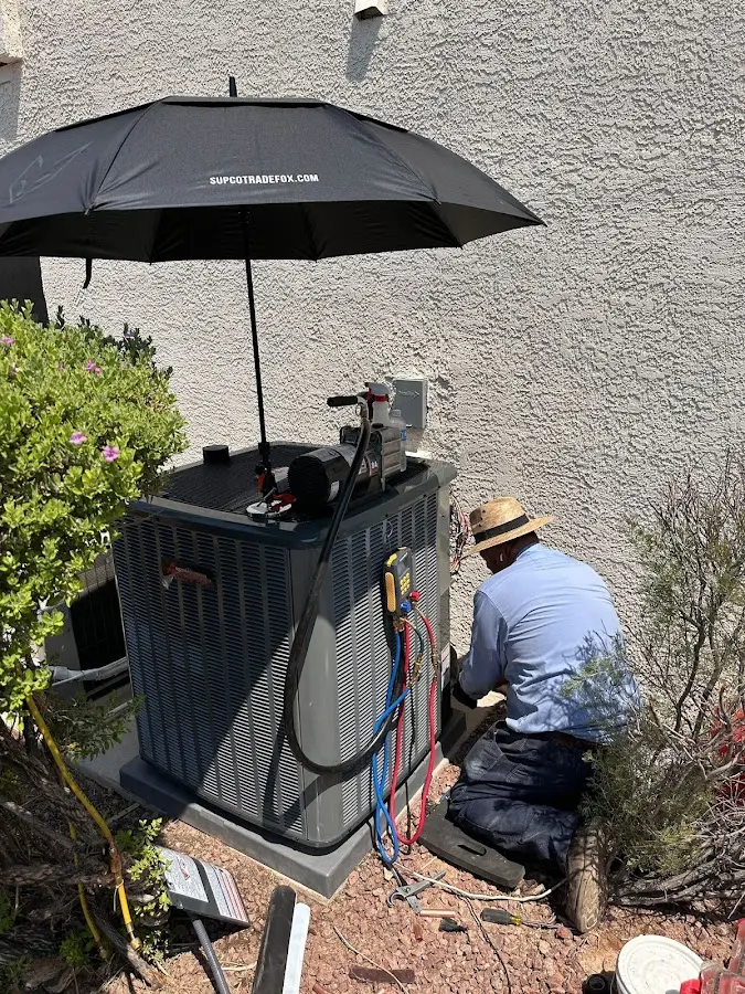HVAC technician performing outdoor AC maintenance in Griswold